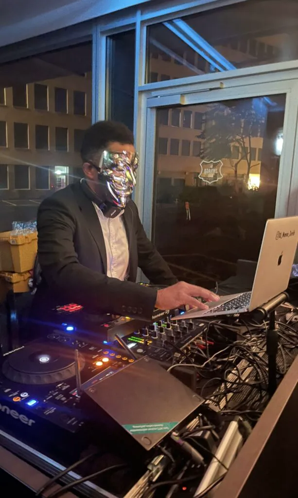 DJ Manoss performing at a corporate event